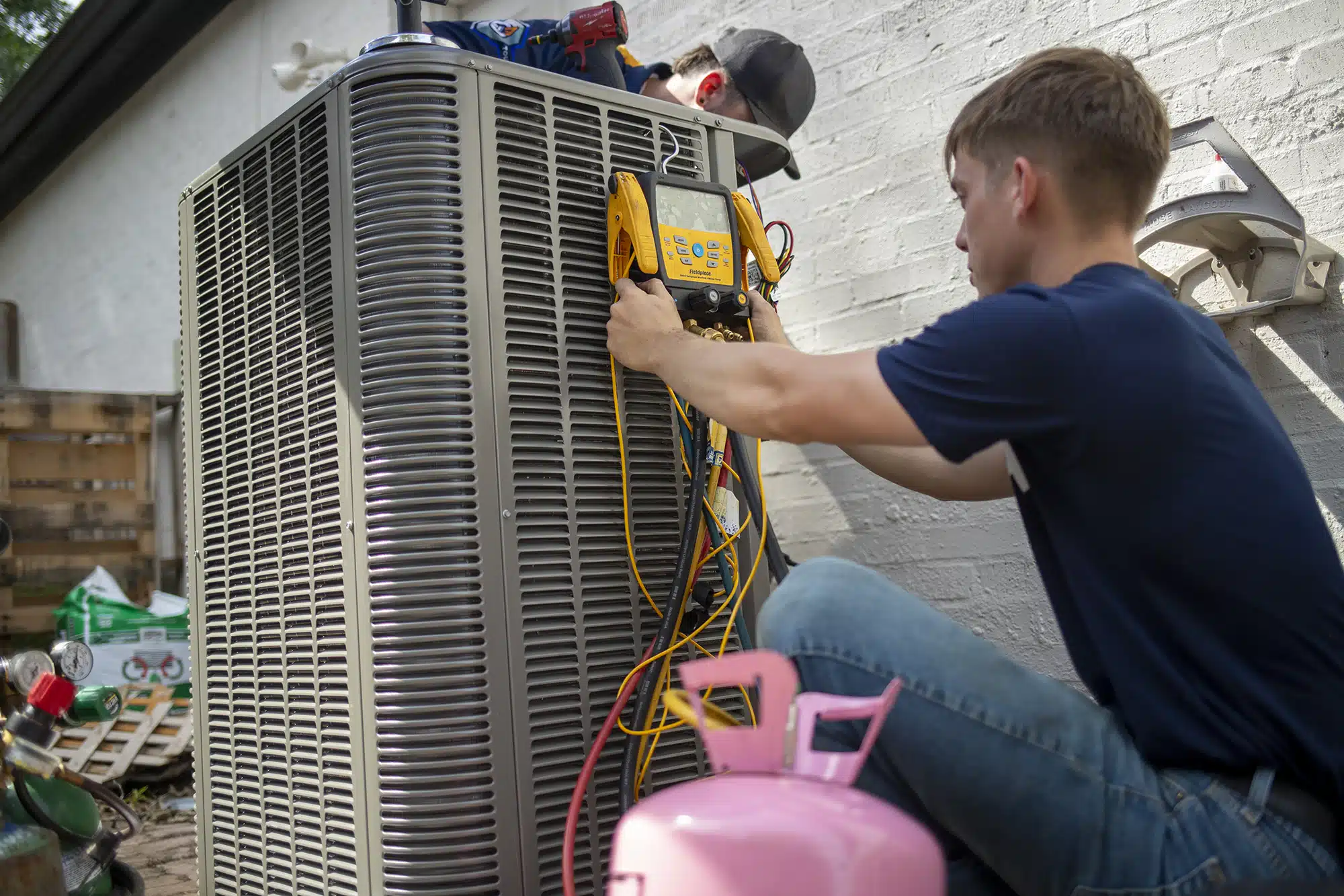 HVAC technician performing air conditioner repair in Owasso, OK