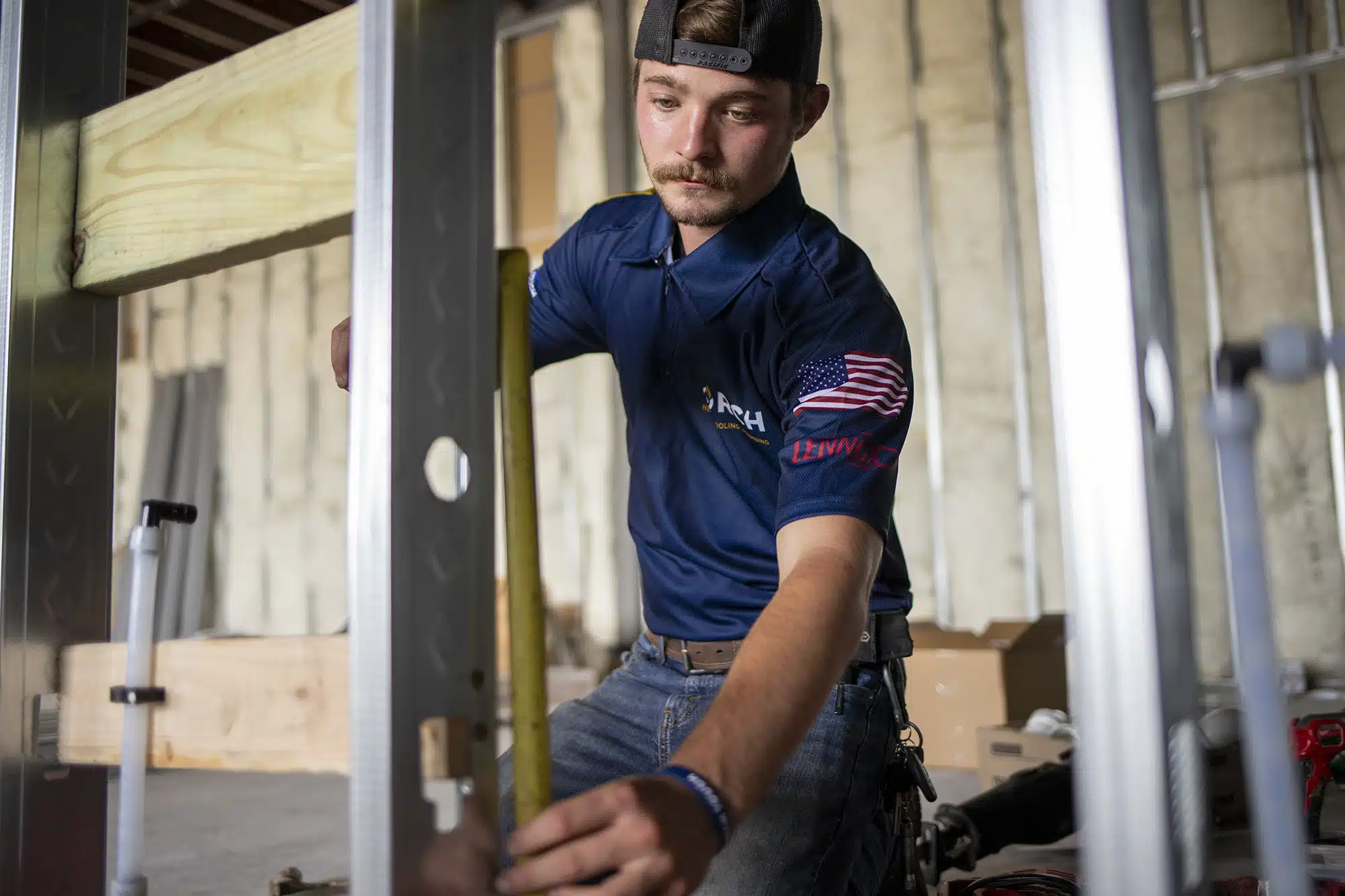 Torch Plumbing, Heating, & Cooling Heating, Cooling and Plumbing Technician measuring for plumbing installation in Owasso, OK