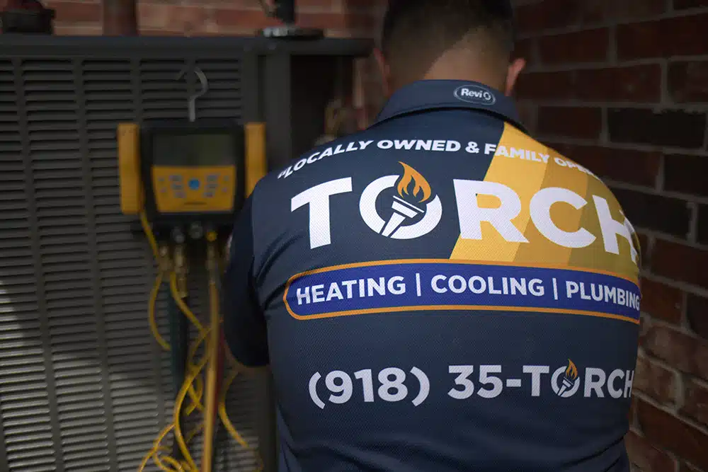 Torch tech repairing an AC unit