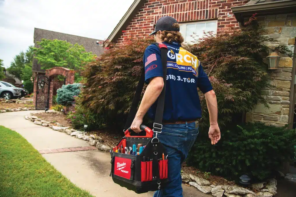 Torch Plumbing, Heating, & Cooling Heating, Cooling, and Plumbing walking into a home in Owasso, OK